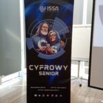 Baner reklamowy promuje program "Cyfrowy Senior" organizacji ISSA Polska, skierowany do osób starszych.