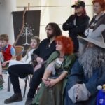 Uczestnicy konwentu ChrzanCon przebrani za postaci ze Śródziemia biorą udział w spotkaniu związanym z obchodek Światowego Dnia Czytania Tolkiena.